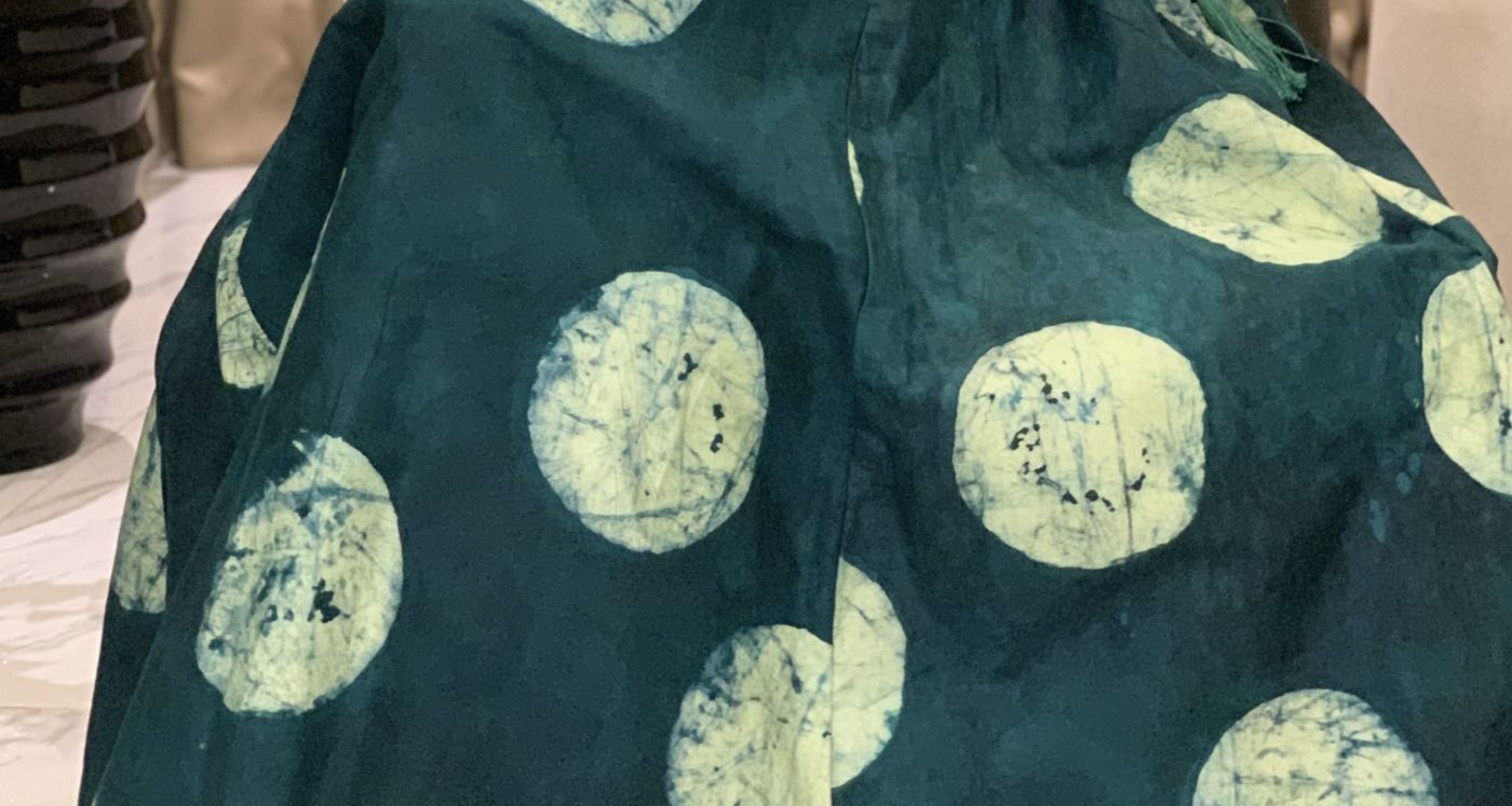 Close-up of teal Àdìrẹ with pale moon circles