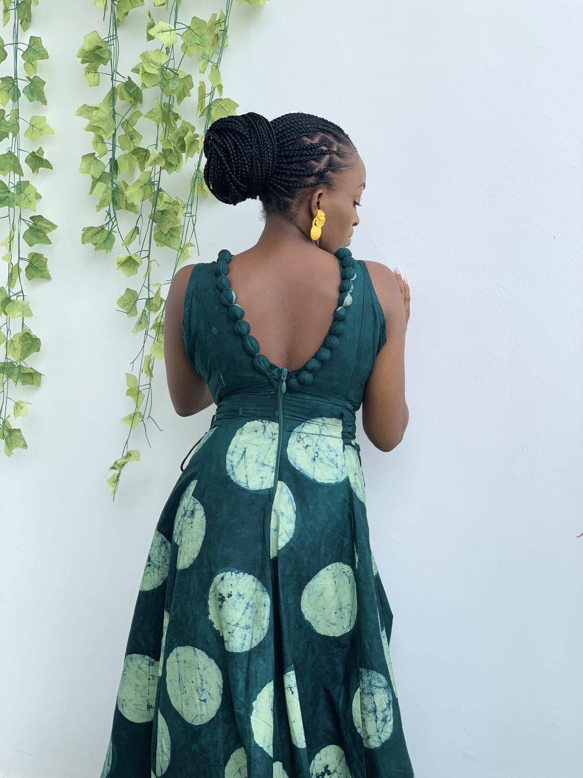 AFẸ́FẸ́ I on model, open pom-pom back in teal Àdìrẹ